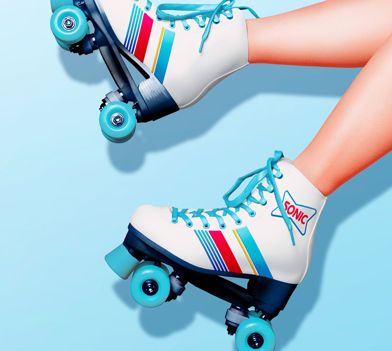 Person wearing Sonic branded skates with blue background