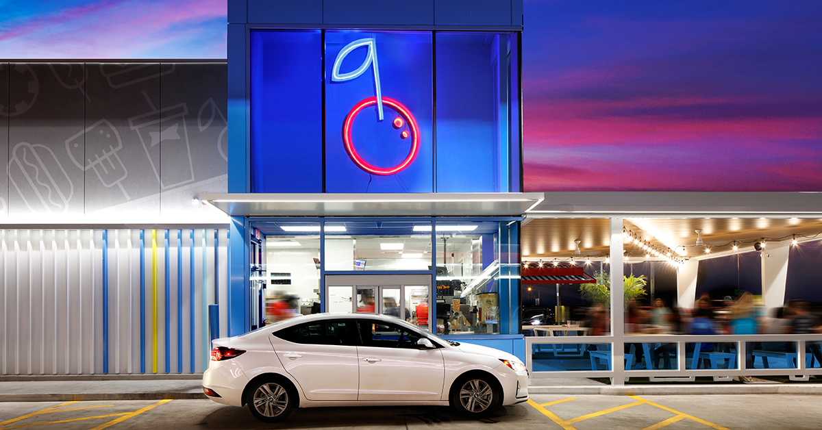 Car parked in front of Sonic with neon cherry sign