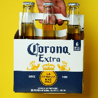 Person holding 6 pack of Corona Extra