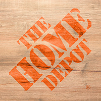 The Home Depot logo with wood background